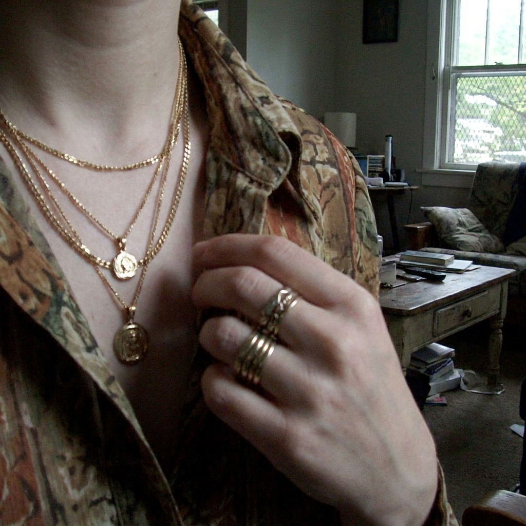 layered jewellery and patterned shirt